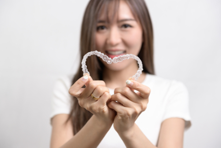 Patient Holding an Invisalign Tray